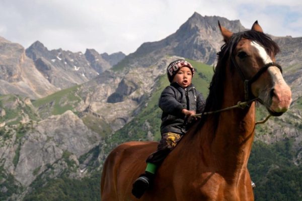 Kyrgyzstan child riding horse